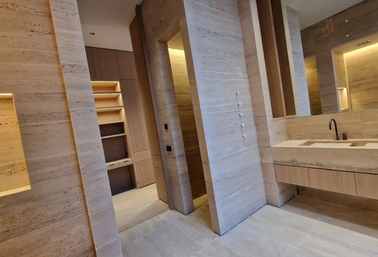 Baño premium reformado por Goldenplac con acabado en travertino